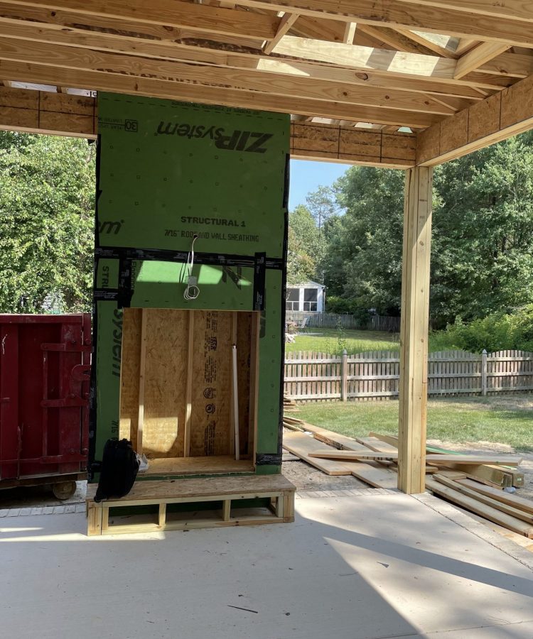 Before photo showing unfinished porch under construction with framed fireplace area in Richmond, VA.